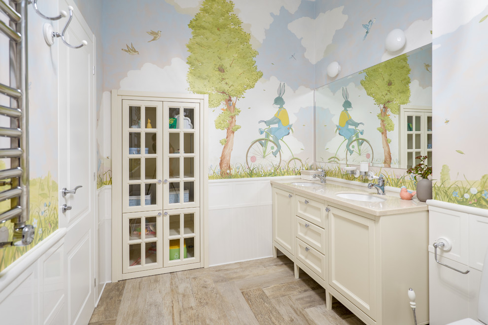 Inspiration for a transitional kids' beige floor bathroom remodel in Saint Petersburg with recessed-panel cabinets, beige cabinets, multicolored walls, an undermount sink and beige countertops