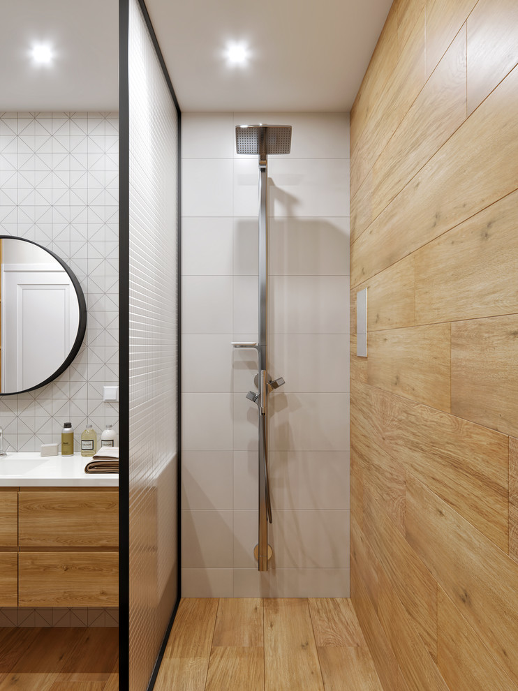Photo of a small contemporary shower room bathroom in Valencia with flat-panel cabinets, light wood cabinets, a walk-in shower, white tiles, porcelain tiles, white walls, porcelain flooring, a wall-mounted sink, solid surface worktops, beige floors, a shower curtain and white worktops.