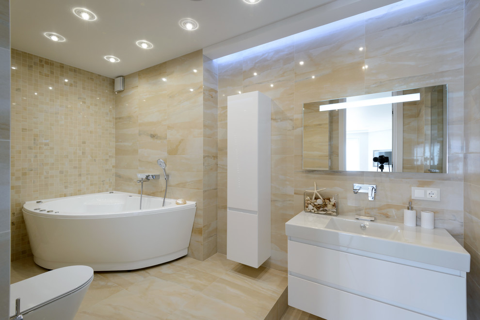 На фото: ванная комната среднего размера в современном стиле с инсталляцией, керамической плиткой и угловой ванной с