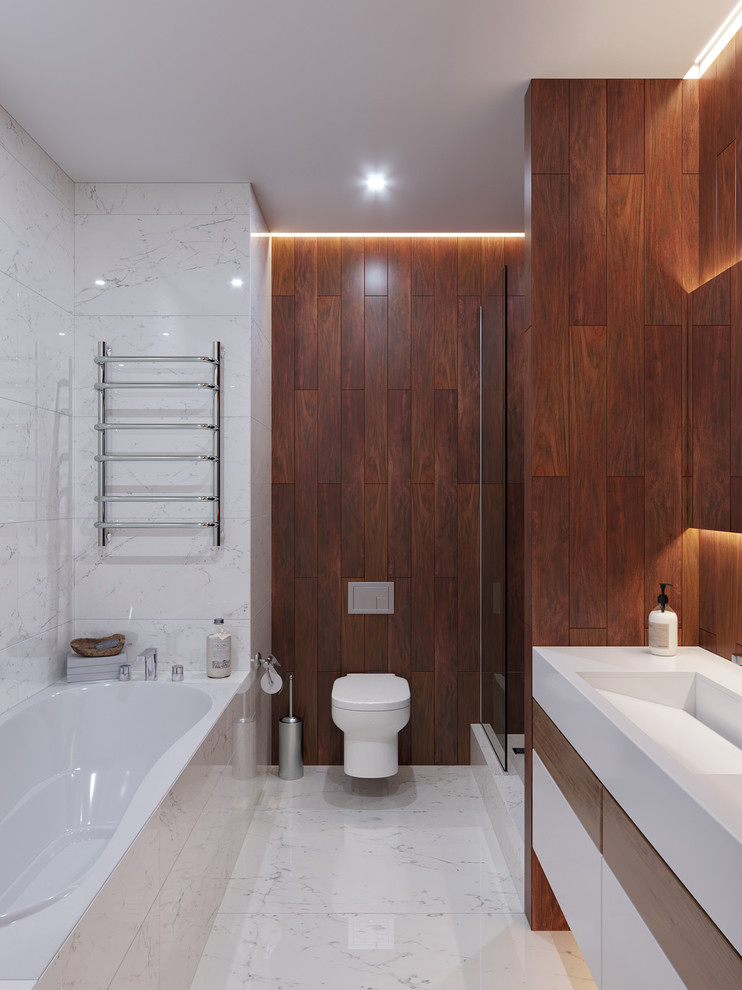 Пример оригинального дизайна: ванная комната среднего размера в современном стиле с полновстраиваемой ванной, душем без бортиков, инсталляцией, белой плиткой, мраморной плиткой, белыми стенами, мраморным полом, душевой кабиной, подвесной раковиной и белым полом