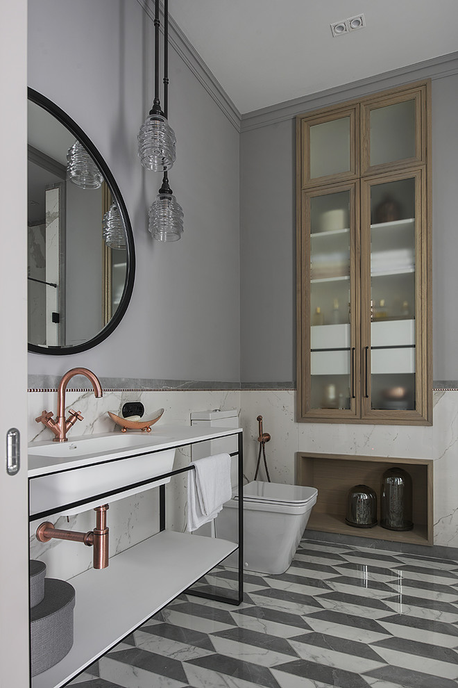 Contemporary bathroom in Moscow with open cabinets, a two-piece toilet, grey walls and grey floors.