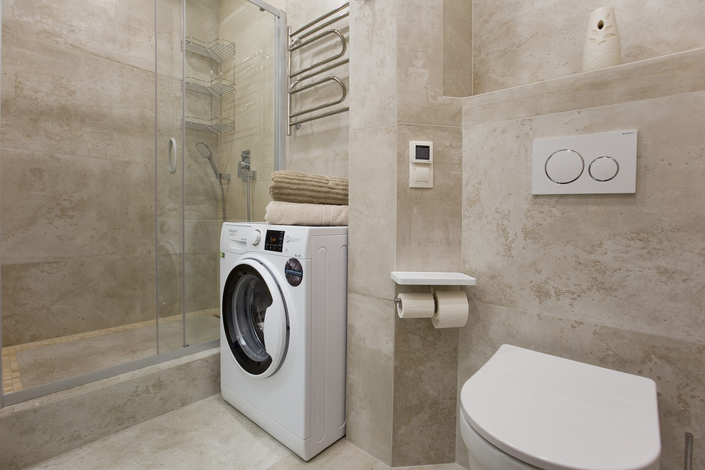 Photo of a medium sized contemporary shower room bathroom in Saint Petersburg with flat-panel cabinets, white cabinets, a built-in shower, a wall mounted toilet, beige tiles, stone tiles, beige walls, porcelain flooring, a built-in sink, beige floors and a shower curtain.