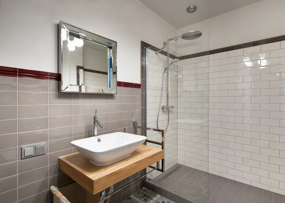 Inspiration for a mid-sized transitional 3/4 black tile, gray tile, multicolored tile, red tile, white tile and subway tile alcove shower remodel in Saint Petersburg with white walls, a vessel sink and wood countertops