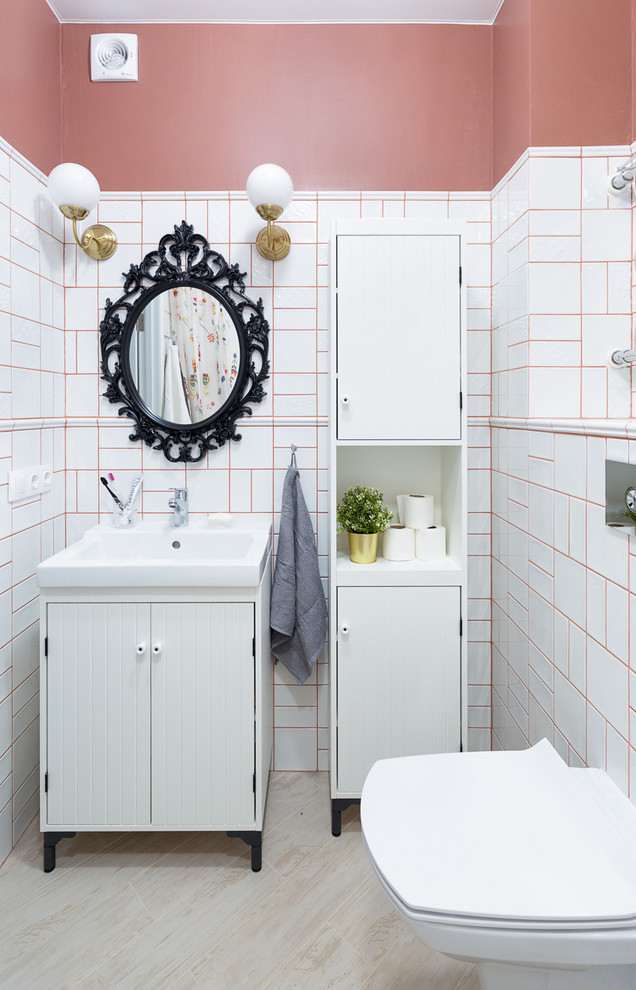 Design ideas for a small contemporary bathroom in Novosibirsk with white cabinets, a wall mounted toilet, white tiles, ceramic tiles, red walls, porcelain flooring, beige floors, flat-panel cabinets and an integrated sink.