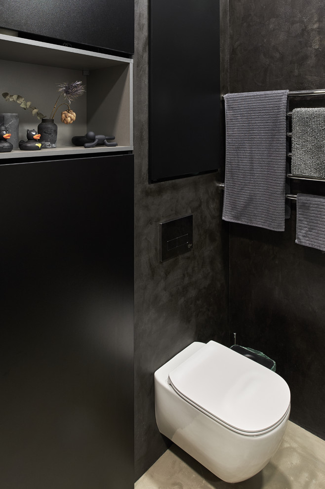 На фото: маленькая ванная комната в современном стиле с черными фасадами, душем в нише, инсталляцией, черными стенами, бетонным полом, душевой кабиной, столешницей из бетона, серым полом, черной столешницей и врезной раковиной для на участке и в саду с