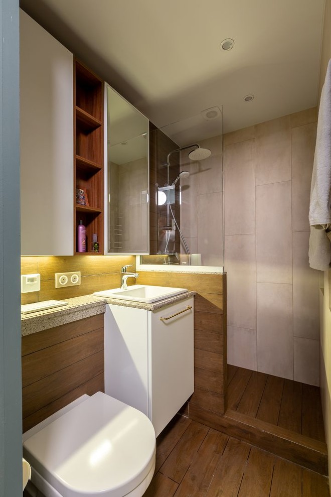 This is an example of a small scandinavian shower room bathroom in Moscow with a built-in shower, a wall mounted toilet, brown tiles, porcelain tiles, beige walls, ceramic flooring, solid surface worktops, brown floors, an open shower and beige worktops.
