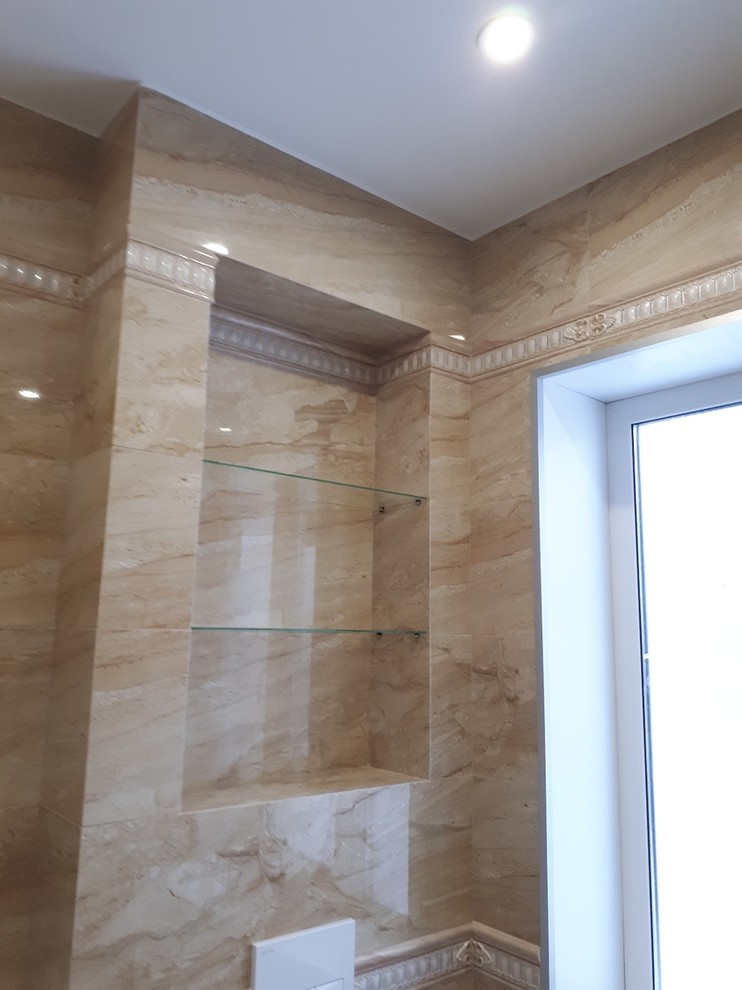 Photo of a classic bathroom in Saint Petersburg with a wall mounted toilet, beige tiles, ceramic tiles, ceramic flooring and beige floors.