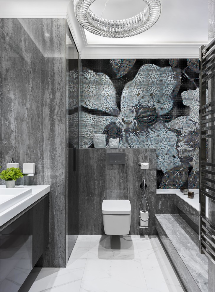 Contemporary ensuite bathroom in Moscow with flat-panel cabinets, black cabinets, a wall mounted toilet, grey tiles, mosaic tiles, a built-in sink, white floors, white worktops, a submerged bath and grey walls.