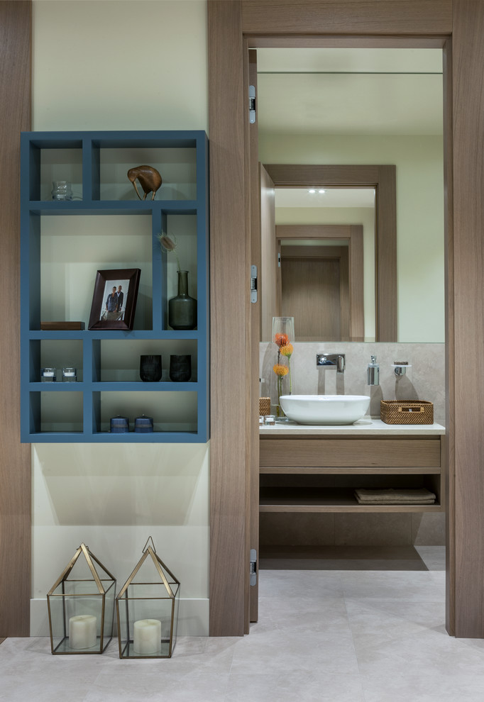 Photo of a medium sized contemporary bathroom in Moscow with flat-panel cabinets, medium wood cabinets, beige tiles, porcelain tiles, porcelain flooring, a vessel sink and engineered stone worktops.