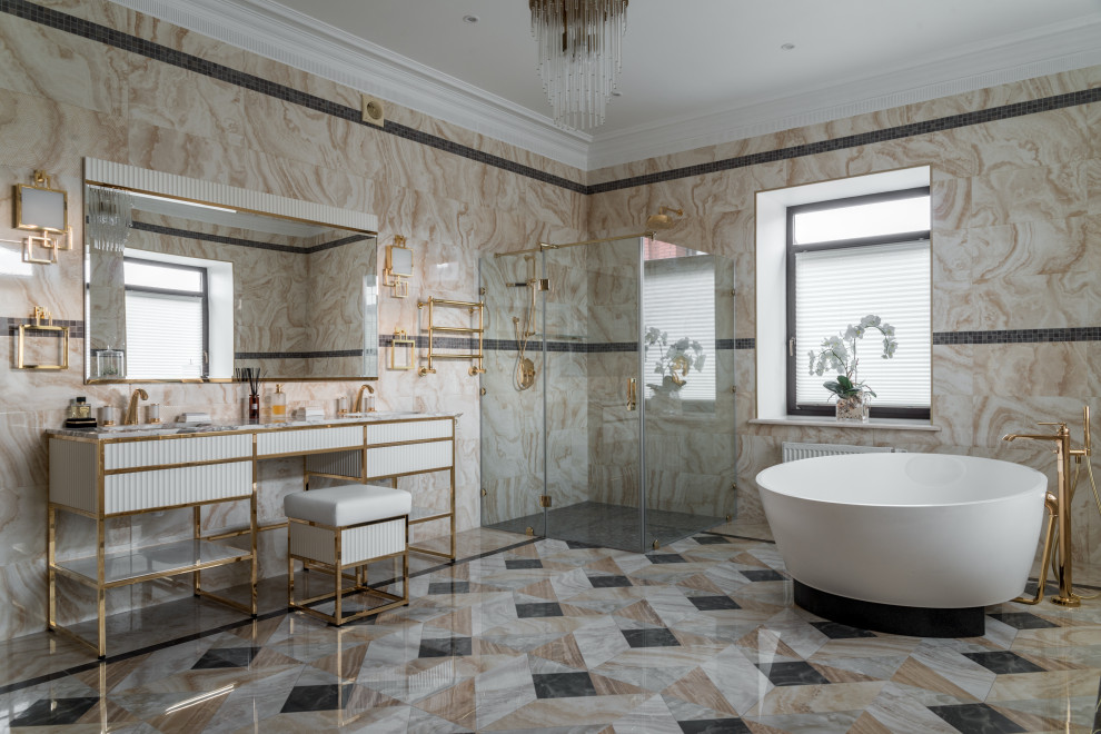 На фото: главная ванная комната в современном стиле с плоскими фасадами, белыми фасадами, отдельно стоящей ванной, угловым душем, бежевой плиткой, врезной раковиной, разноцветным полом и белой столешницей с