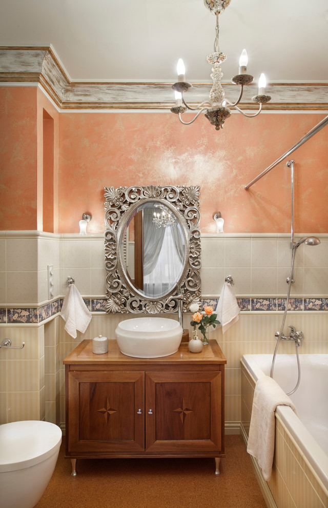 На фото: главная ванная комната в классическом стиле с настольной раковиной, фасадами с утопленной филенкой, фасадами цвета дерева среднего тона, накладной ванной, белой плиткой и шторкой для ванной с