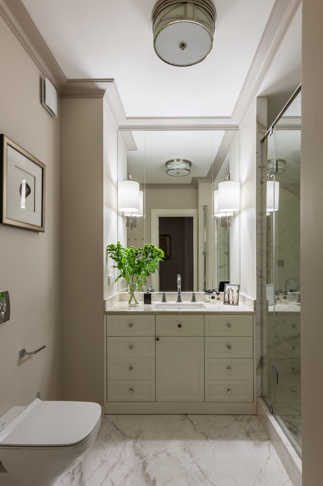 This is an example of a small classic shower room bathroom in Moscow with recessed-panel cabinets, white cabinets, an alcove shower, a wall mounted toilet, beige walls, a submerged sink, a hinged door, marble flooring and white floors.