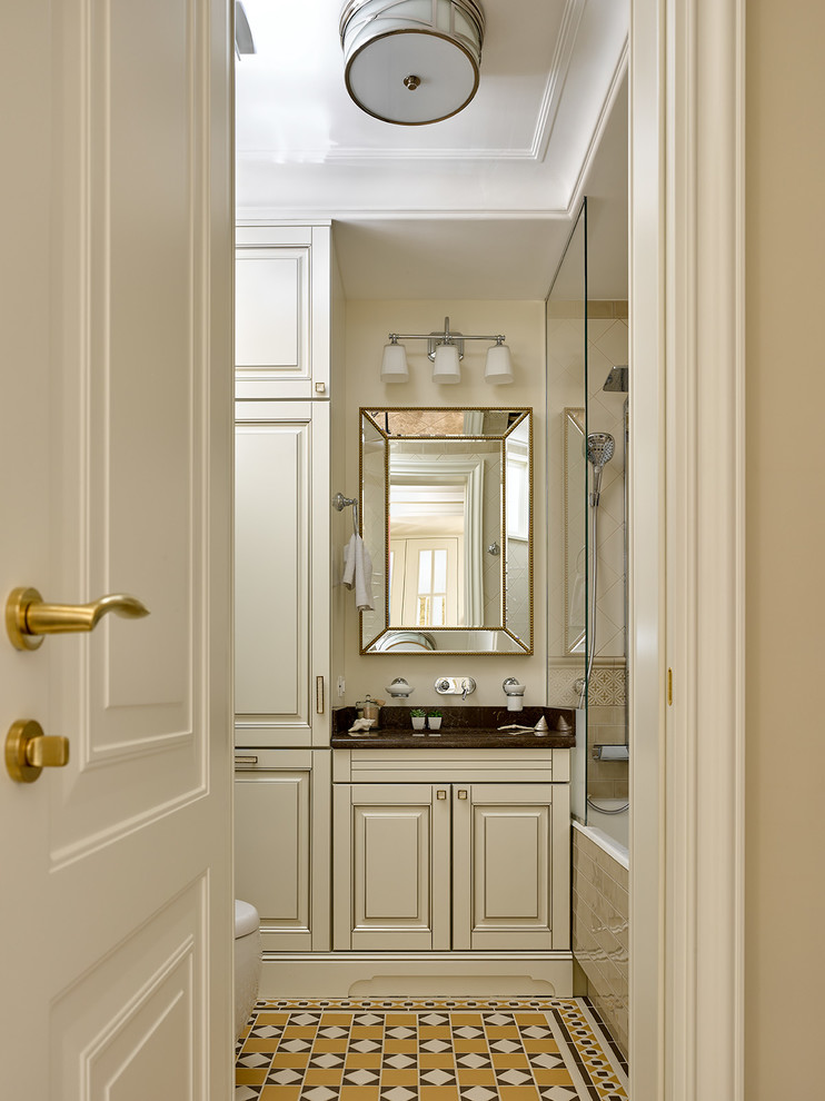 Ejemplo de cuarto de baño principal clásico con armarios con paneles con relieve, puertas de armario blancas, bañera empotrada, paredes beige y suelo multicolor