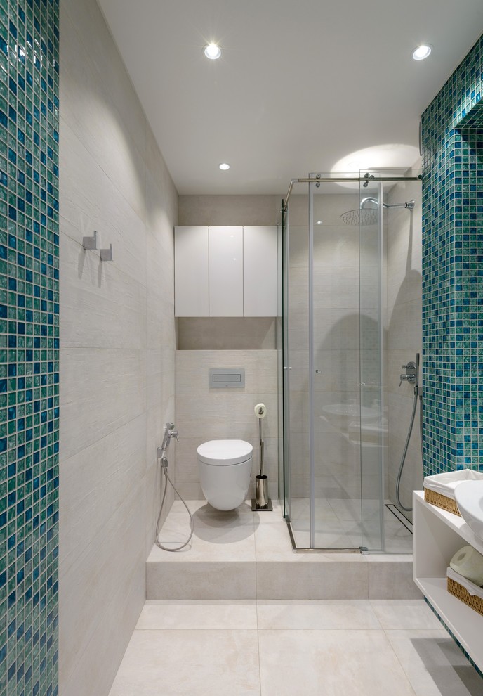 This is an example of a contemporary shower room bathroom in Moscow with open cabinets, a corner shower, a wall mounted toilet, blue tiles, beige tiles, mosaic tiles, a vessel sink, beige floors and a sliding door.