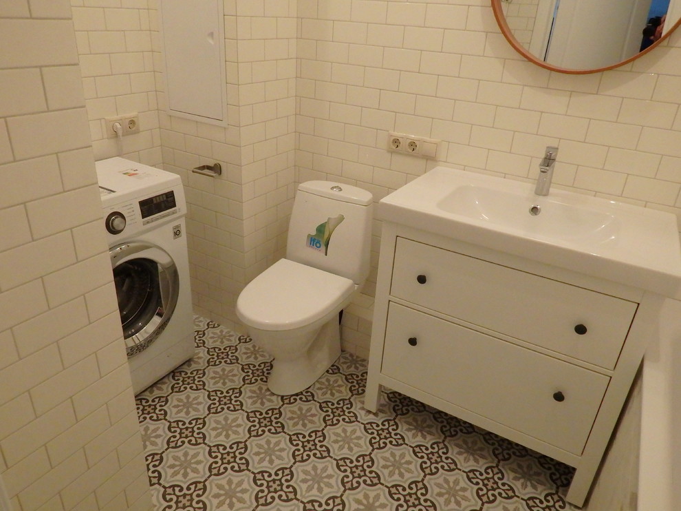 Example of a mid-sized urban master ceramic tile and brown floor bathroom design in Moscow with flat-panel cabinets, white cabinets, an undermount tub, a one-piece toilet, gray walls and a drop-in sink