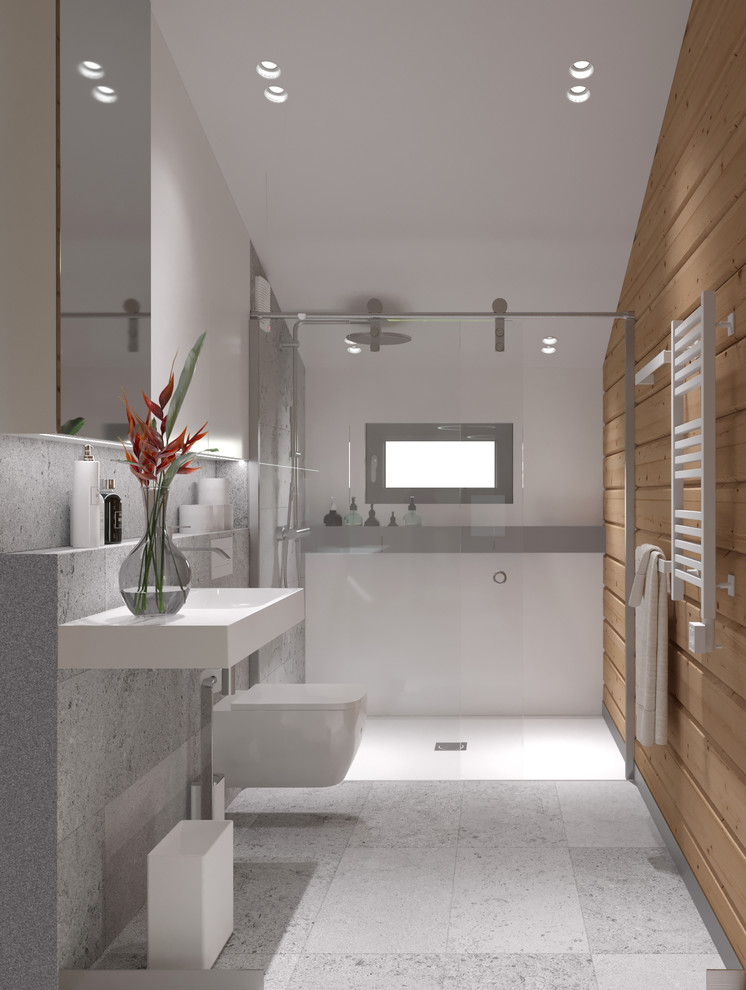 Пример оригинального дизайна: маленькая ванная комната в скандинавском стиле с стеклянными фасадами, серыми фасадами, душем без бортиков, инсталляцией, серой плиткой, керамогранитной плиткой, серыми стенами, полом из керамогранита, душевой кабиной, подвесной раковиной, столешницей из искусственного камня, серым полом и душем с раздвижными дверями для на участке и в саду