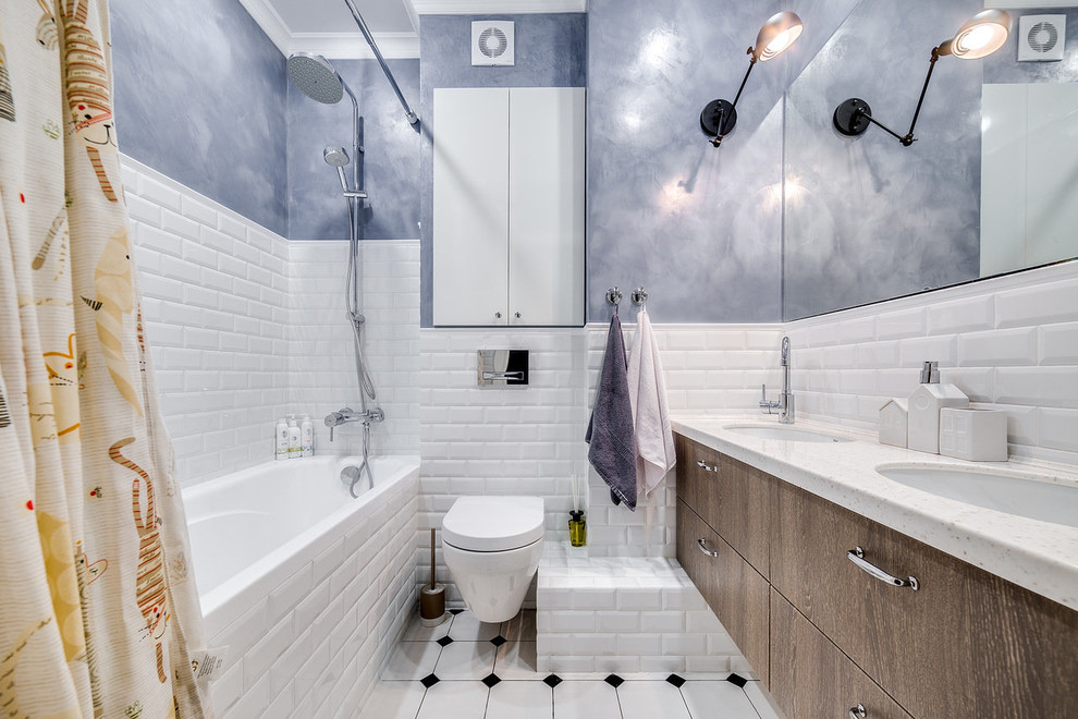 Small scandinavian family bathroom in Saint Petersburg with flat-panel cabinets, a shower/bath combination, a wall mounted toilet, white tiles, ceramic tiles, ceramic flooring, a submerged sink, solid surface worktops, white floors, a shower curtain, medium wood cabinets, an alcove bath, blue walls and white worktops.