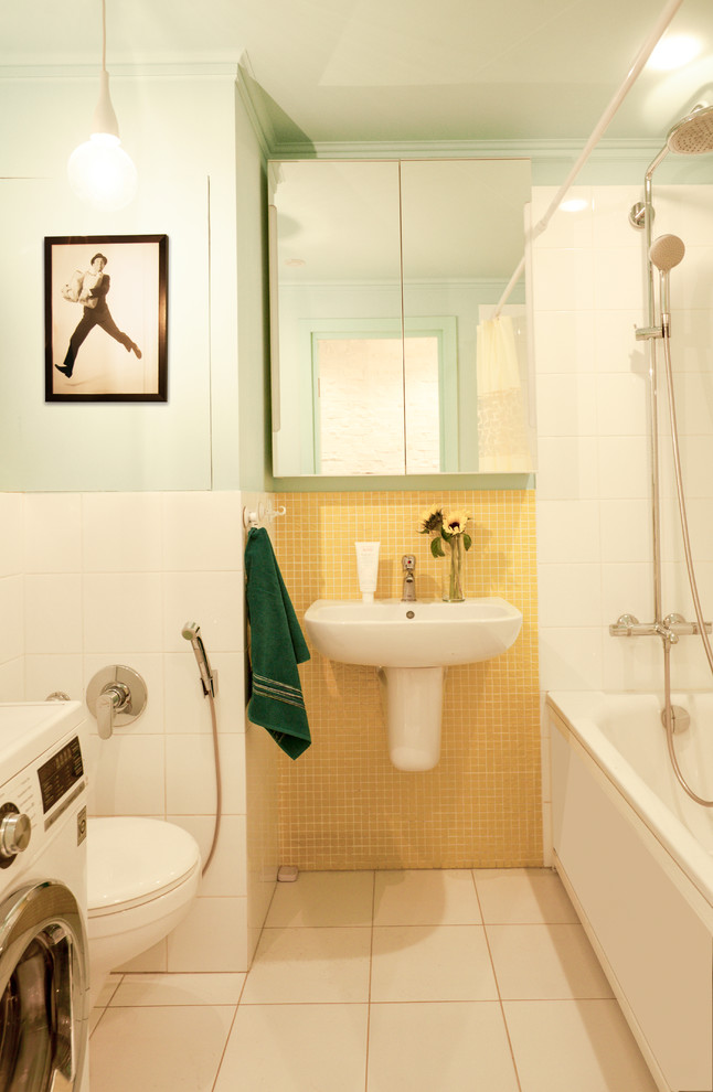 Стильный дизайн: маленькая главная ванная комната в скандинавском стиле с полновстраиваемой ванной, инсталляцией, желтой плиткой, керамической плиткой, синими стенами, полом из керамической плитки, подвесной раковиной и белым полом для на участке и в саду - последний тренд