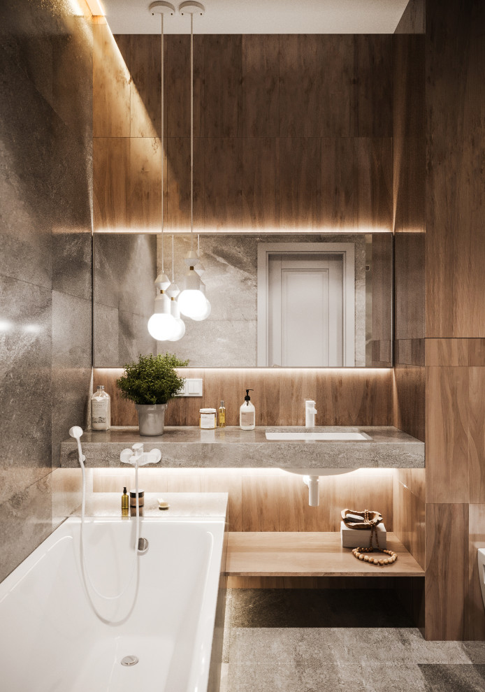 Idéer för ett mellanstort modernt grå badrum med dusch, med ett undermonterat badkar, en dusch i en alkov, en vägghängd toalettstol, grå kakel, porslinskakel, grå väggar, klinkergolv i porslin, ett undermonterad handfat, kaklad bänkskiva och grått golv