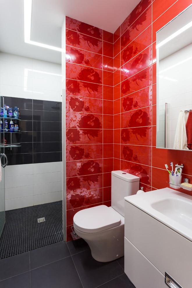 This is an example of a small contemporary bathroom in Saint Petersburg with flat-panel cabinets, white cabinets, red tiles, ceramic tiles, white walls, ceramic flooring, a built-in sink, black floors and a hinged door.