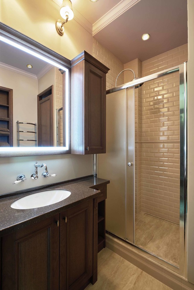 Photo of a small classic shower room bathroom in Moscow with an alcove shower, a submerged sink, recessed-panel cabinets, dark wood cabinets, beige tiles, ceramic tiles, beige walls, ceramic flooring and solid surface worktops.