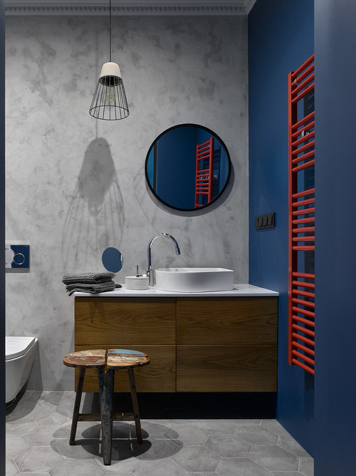 Industrial Chic: Modern Industrial Bathroom with a Blue Wall and Red Towel Rack