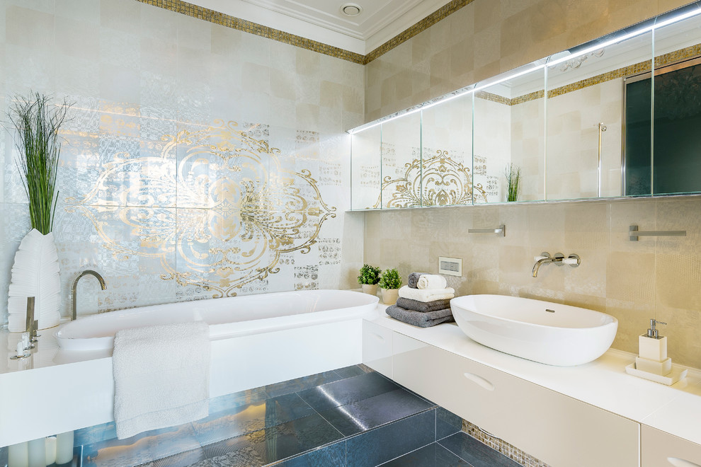 На фото: главная ванная комната в современном стиле с плоскими фасадами, белыми фасадами, накладной ванной, бежевой плиткой, настольной раковиной и бежевыми стенами