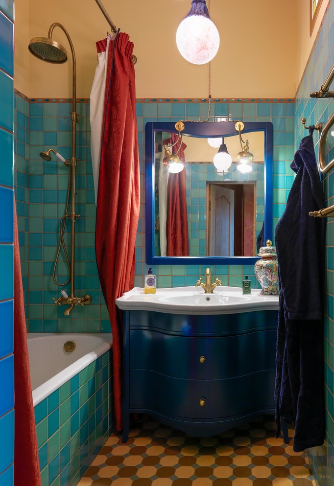 На фото: маленькая главная ванная комната в стиле ретро с плоскими фасадами, синими фасадами, ванной в нише, душем над ванной, зеленой плиткой, керамической плиткой, бежевыми стенами, полом из керамической плитки, консольной раковиной, коричневым полом и шторкой для ванной для на участке и в саду