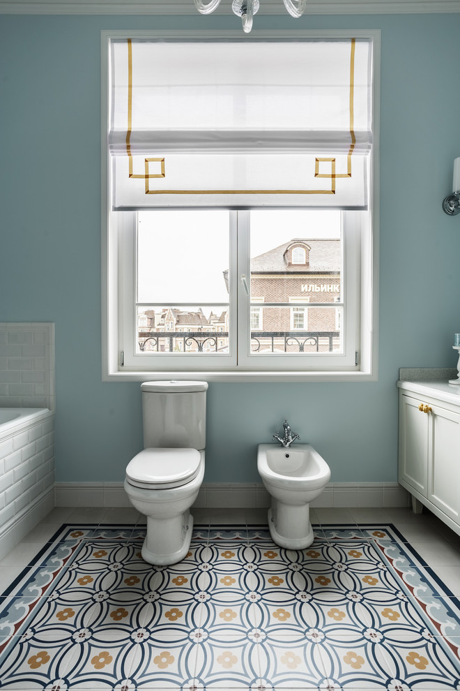 Immagine di una grande stanza da bagno tradizionale con ante bianche, WC a due pezzi, pareti grigie, pavimento con piastrelle in ceramica, top in superficie solida, pavimento multicolore e ante con riquadro incassato