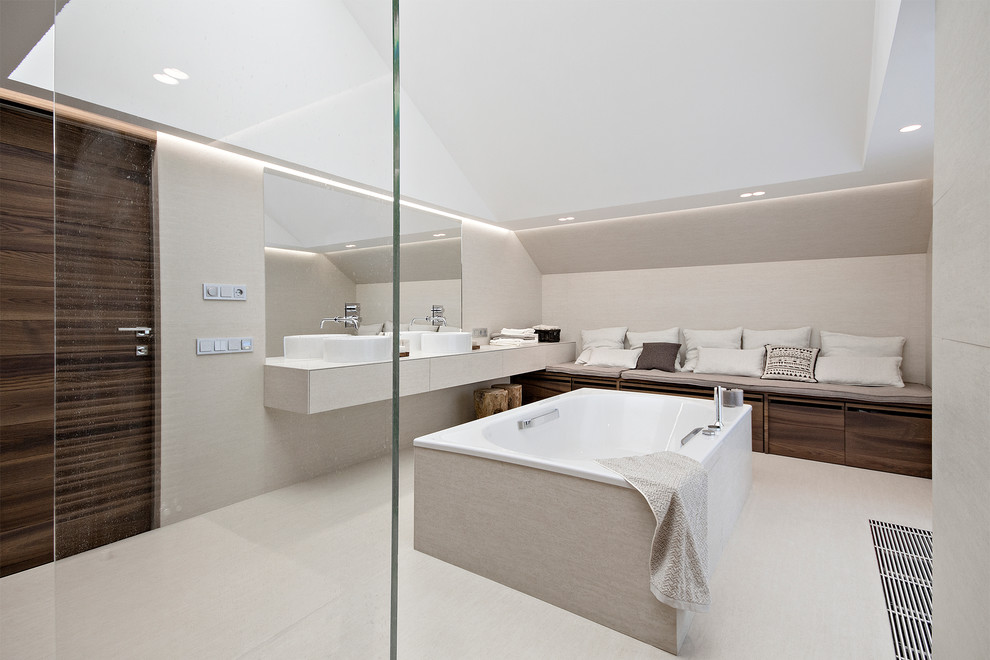 Идея дизайна: ванная комната в современном стиле с отдельно стоящей ванной, бежевой плиткой, серыми стенами и настольной раковиной