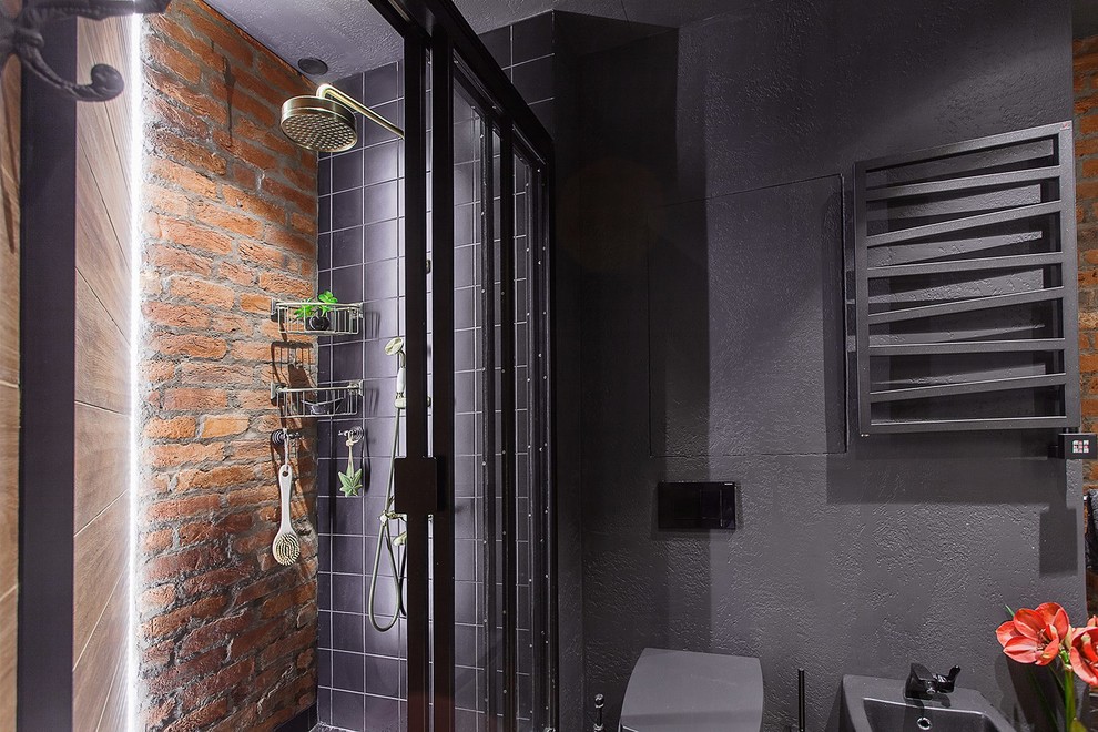 Industrial bathroom in Saint Petersburg with an alcove shower, a two-piece toilet and black walls.