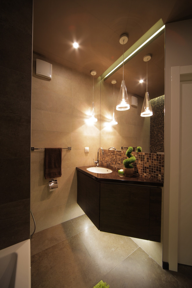 Immagine di una stanza da bagno contemporanea di medie dimensioni con lavabo sottopiano, pareti beige e pavimento marrone
