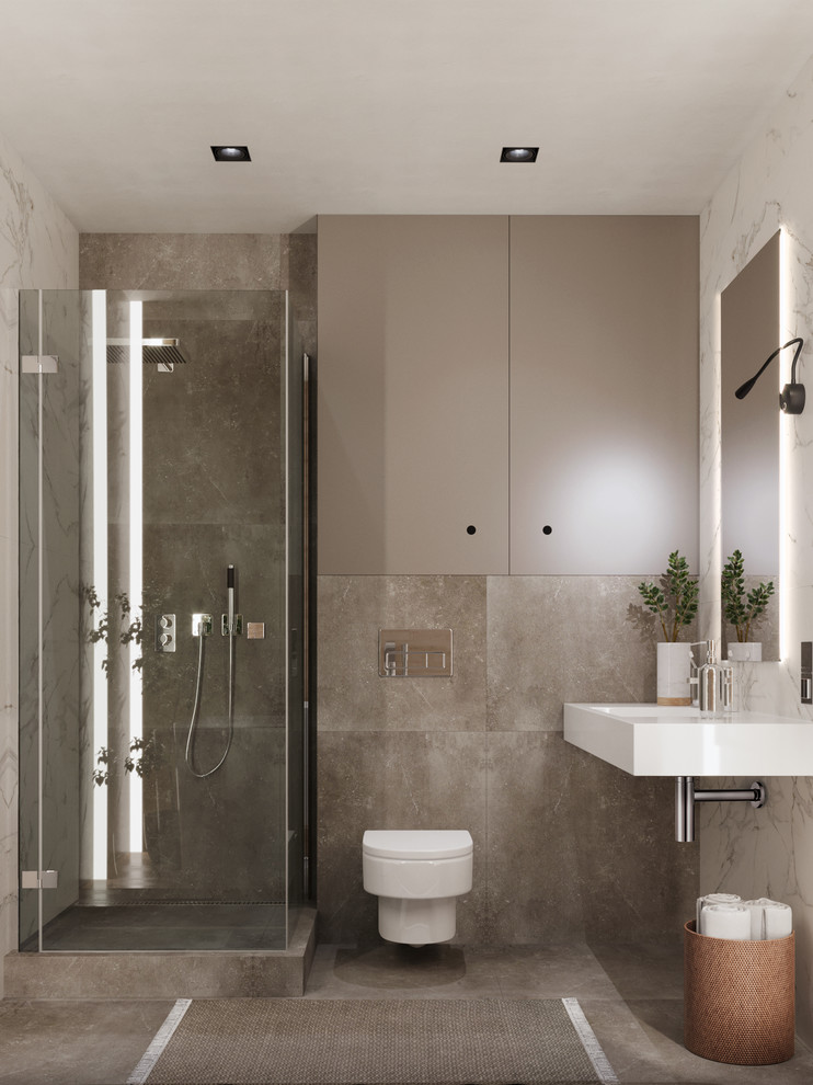 Small contemporary shower room bathroom in Valencia with a freestanding bath, a wall mounted toilet, beige tiles, porcelain tiles, multi-coloured walls, porcelain flooring, a wall-mounted sink, solid surface worktops, grey floors, a hinged door and white worktops.