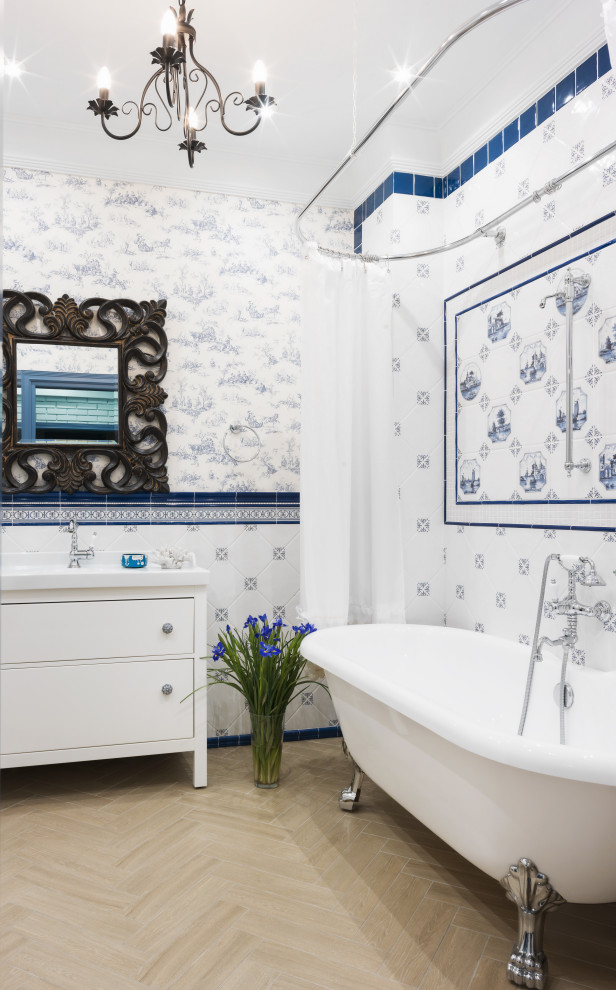 This is an example of a mediterranean bathroom in Moscow with white cabinets, a claw-foot bath, a shower/bath combination, blue tiles, white tiles, multi-coloured walls, beige floors, a shower curtain, white worktops and flat-panel cabinets.