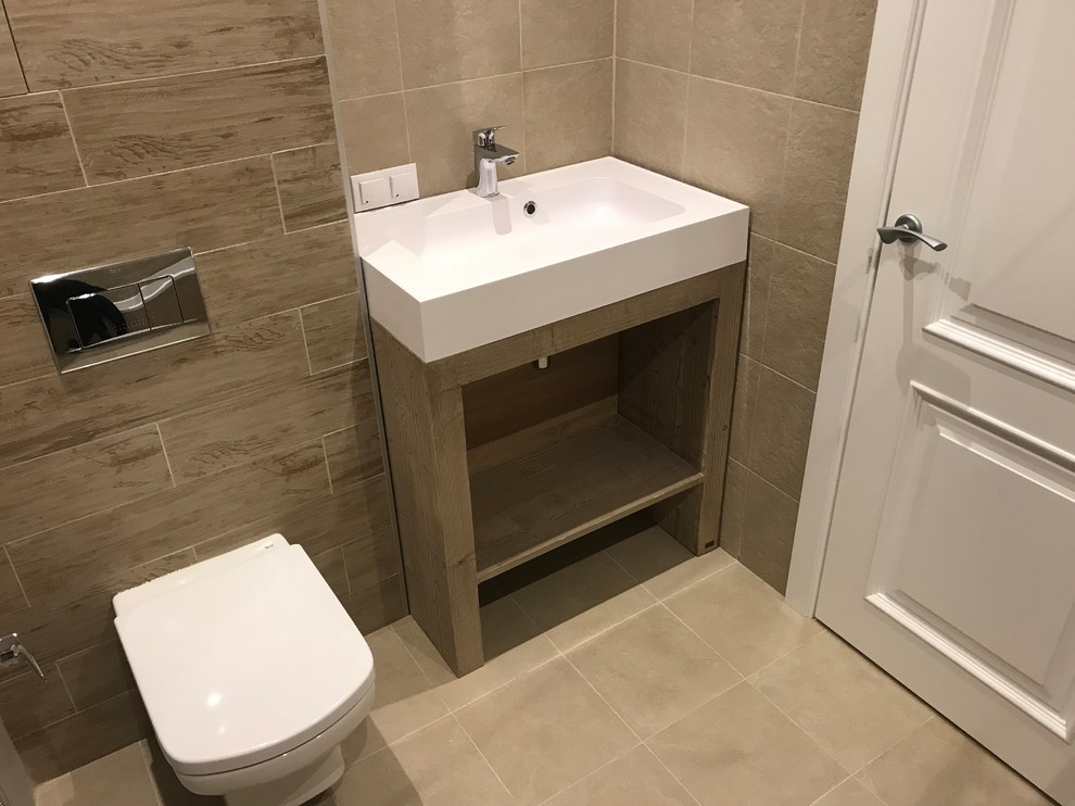Medium sized urban ensuite bathroom in Other with a submerged bath, a wall mounted toilet, beige tiles, porcelain tiles, beige walls, porcelain flooring, a built-in sink, beige floors and a shower curtain.