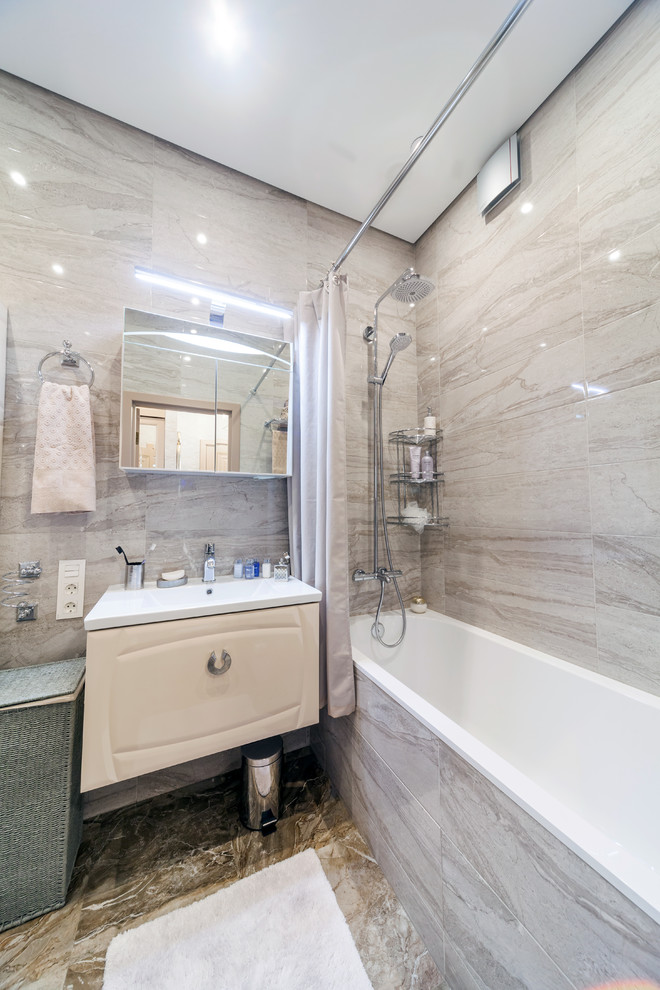 Small transitional master beige tile and ceramic tile porcelain tile and beige floor bathroom photo in Saint Petersburg with raised-panel cabinets, beige cabinets, an undermount tub, a wall-mount toilet, beige walls and a drop-in sink