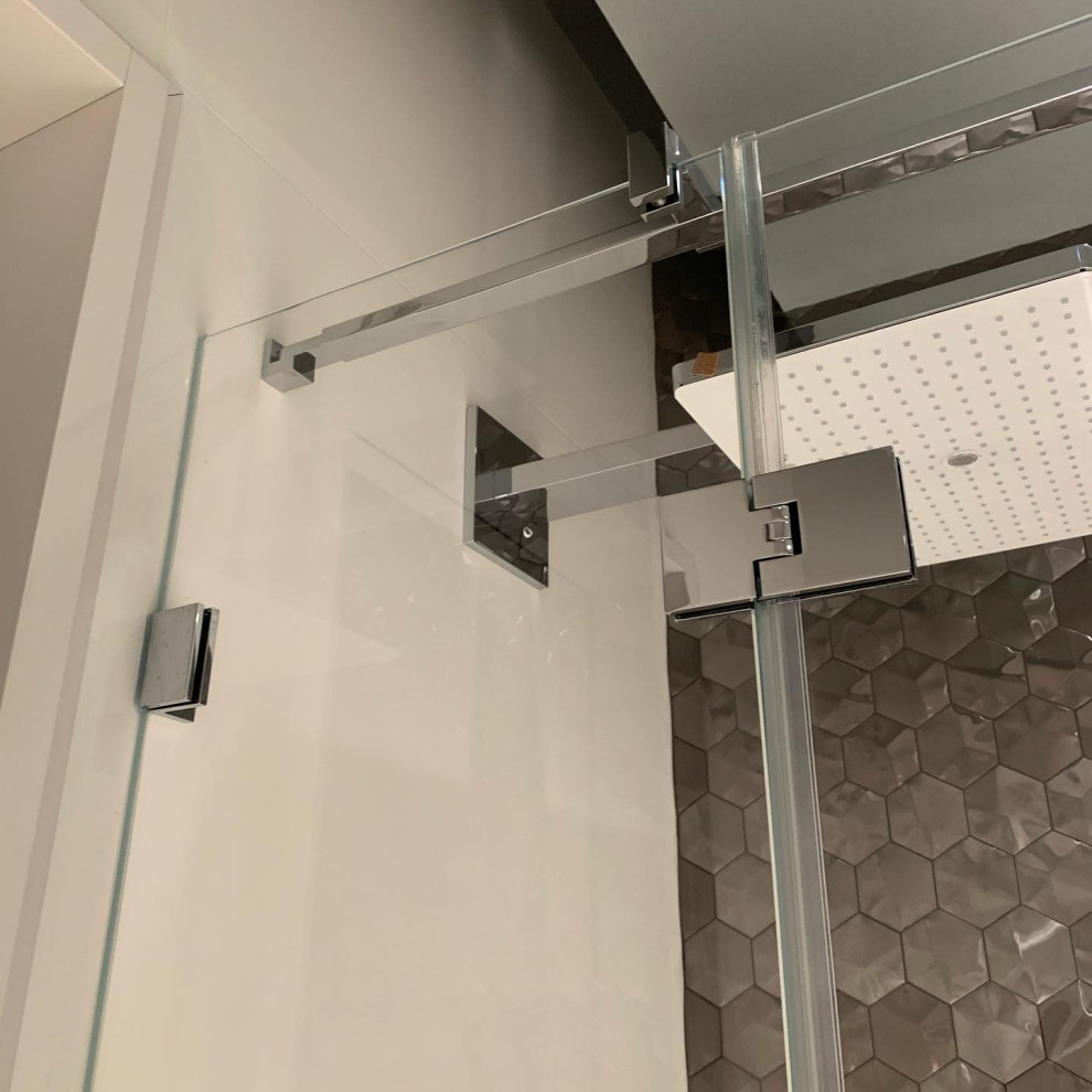 Foto de cuarto de baño actual de tamaño medio con ducha esquinera, aseo y ducha y ducha con puerta con bisagras