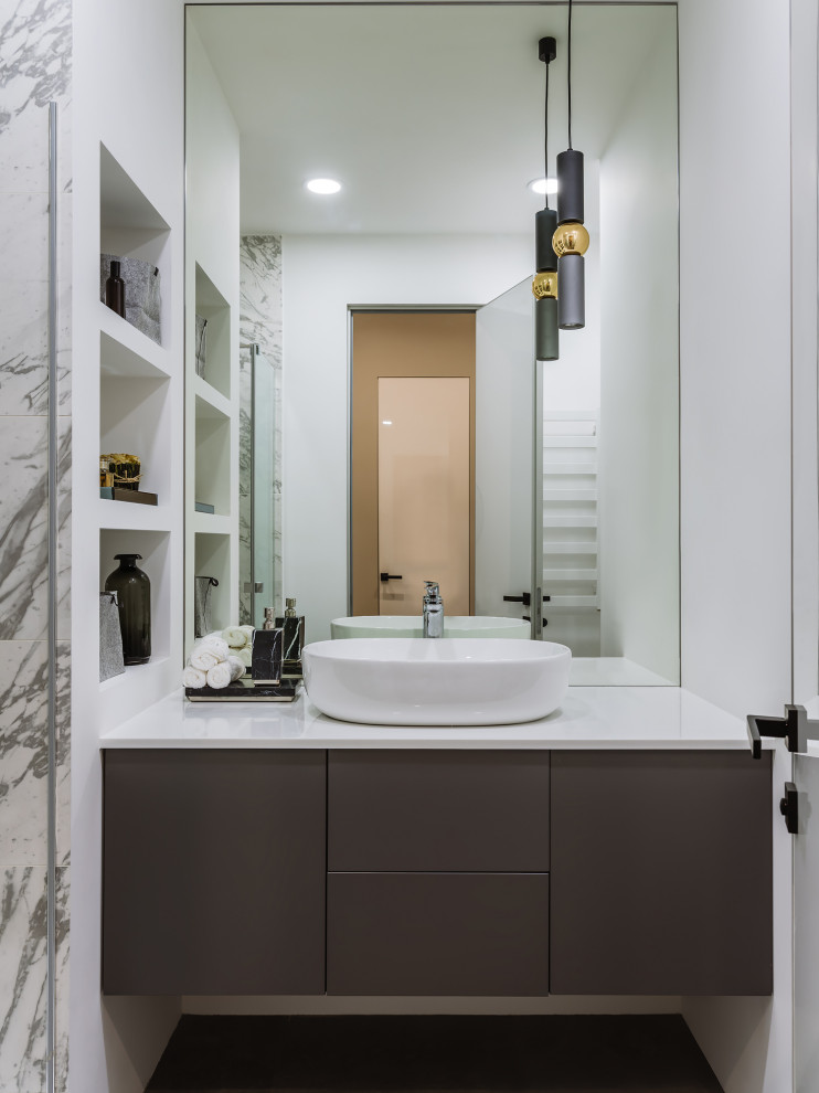 Photo of a medium sized contemporary grey and white shower room bathroom in Moscow with flat-panel cabinets, grey cabinets, an alcove shower, a wall mounted toilet, white tiles, porcelain tiles, white walls, porcelain flooring, a built-in sink, solid surface worktops, grey floors, a hinged door, white worktops, a single sink, a floating vanity unit and a wall niche.