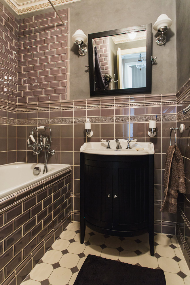 Design ideas for a traditional ensuite bathroom in Moscow with brown tiles, metro tiles, black cabinets, a built-in bath, a shower/bath combination, grey walls and an integrated sink.