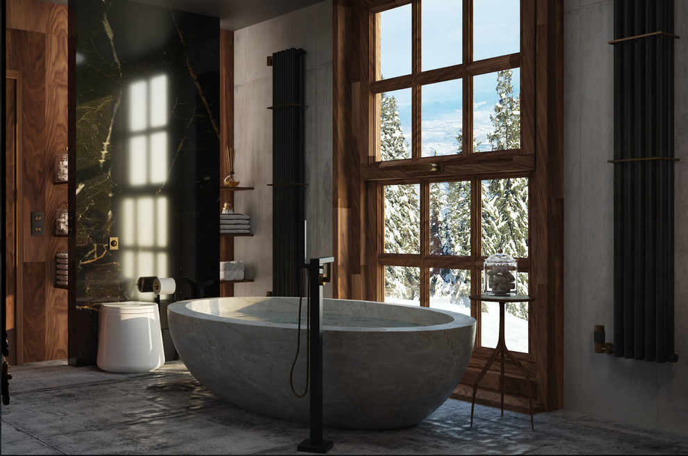 Klassisk inredning av ett stort svart svart en-suite badrum, med släta luckor, skåp i mellenmörkt trä, ett fristående badkar, en dusch/badkar-kombination, en bidé, grå kakel, cementkakel, grå väggar, cementgolv, ett undermonterad handfat, marmorbänkskiva och grått golv