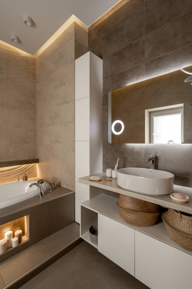 This is an example of a contemporary bathroom in Other with flat-panel cabinets, white cabinets, a built-in bath, beige tiles, a vessel sink, grey floors, beige worktops, a single sink and a floating vanity unit.