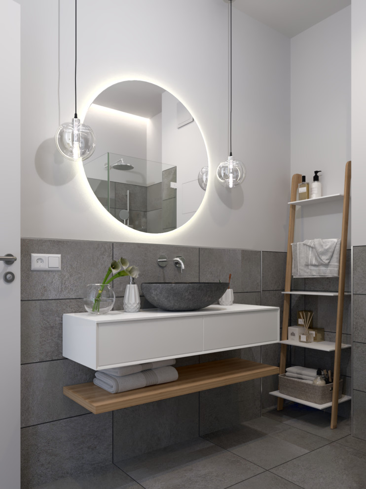 Bathroom - mid-sized contemporary master gray tile and ceramic tile ceramic tile, gray floor and single-sink bathroom idea with flat-panel cabinets, white cabinets, a wall-mount toilet, white walls, a vessel sink, solid surface countertops, white countertops and a floating vanity