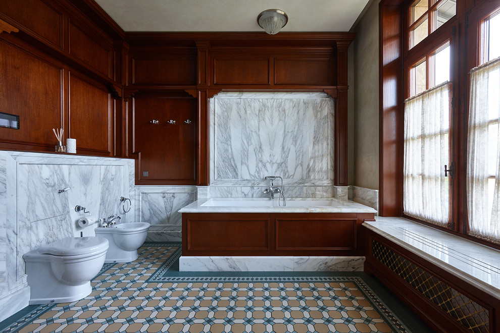 Esempio di una stanza da bagno padronale tradizionale con bidè, piastrelle grigie, pareti marroni, pavimento multicolore e vasca da incasso
