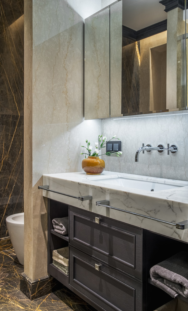 Foto på ett mellanstort vintage badrum med dusch, med beige kakel, marmorkakel, marmorgolv, ett undermonterad handfat, marmorbänkskiva, brunt golv, luckor med infälld panel och grå skåp