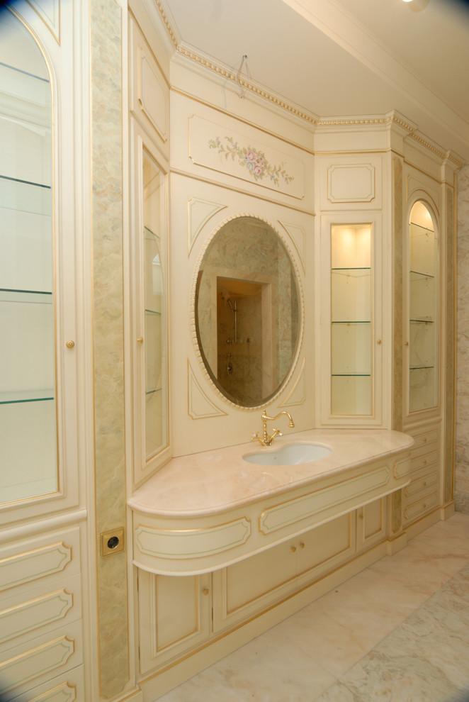 Inspiration for an expansive traditional ensuite bathroom in Moscow with raised-panel cabinets, beige cabinets, beige tiles, marble tiles, pink walls, marble flooring, a submerged sink, onyx worktops, pink floors and pink worktops.