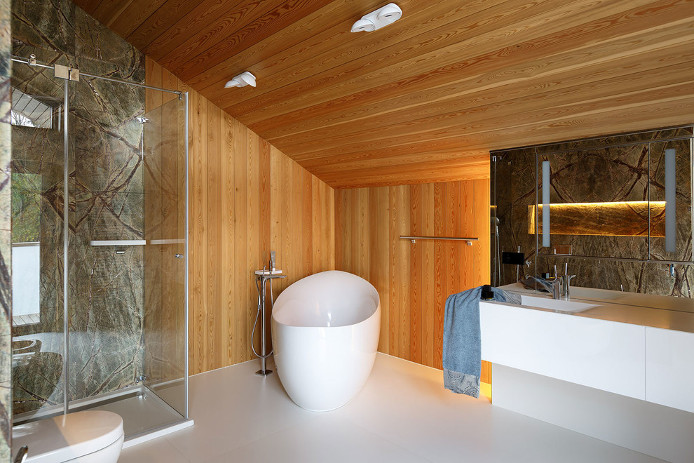 Cette image montre une salle de bain principale design avec un placard à porte plane, des portes de placard blanches, une baignoire indépendante, une douche d'angle, un mur marron et un lavabo intégré.