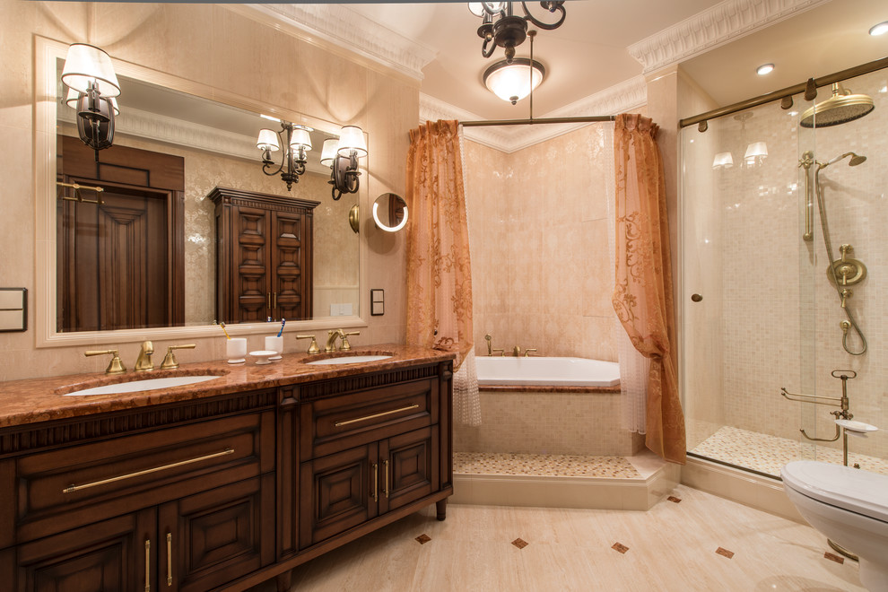 Foto de cuarto de baño clásico con puertas de armario de madera en tonos medios, bañera esquinera, ducha empotrada, baldosas y/o azulejos beige, lavabo bajoencimera y ducha con puerta corredera
