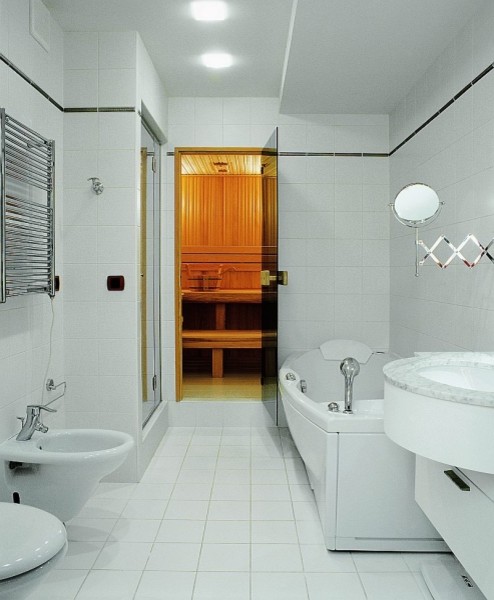 Photo of a medium sized classic ensuite bathroom in Other with flat-panel cabinets, white cabinets, a hot tub, an alcove shower, a bidet, white tiles, ceramic tiles, white walls, ceramic flooring, a submerged sink and marble worktops.
