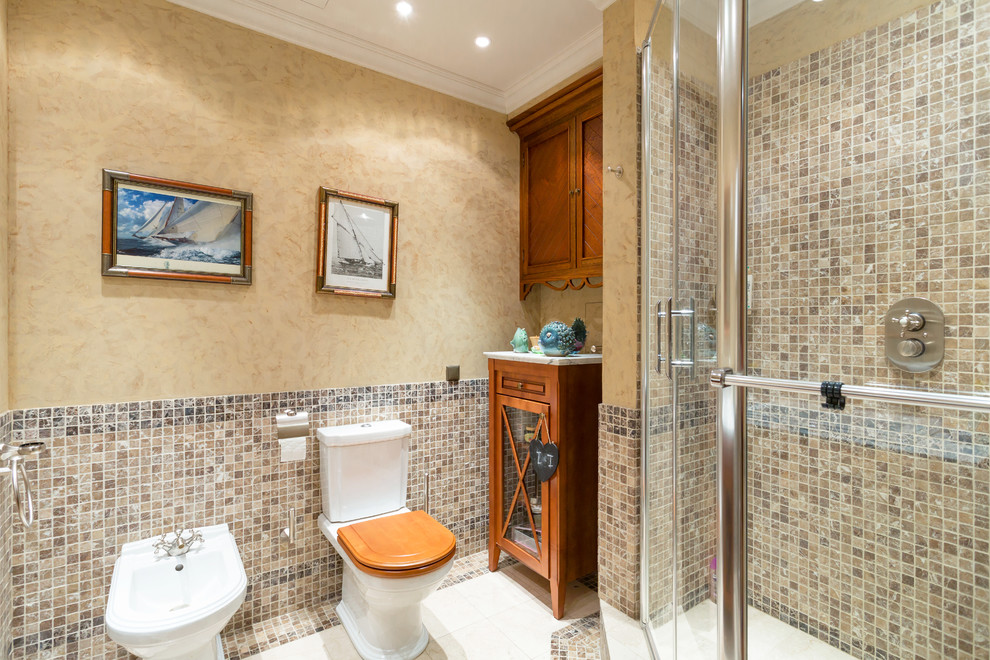Foto di una stanza da bagno con doccia tradizionale di medie dimensioni con doccia ad angolo, bidè, piastrelle marroni, pareti beige, lavabo da incasso, pavimento beige e porta doccia a battente