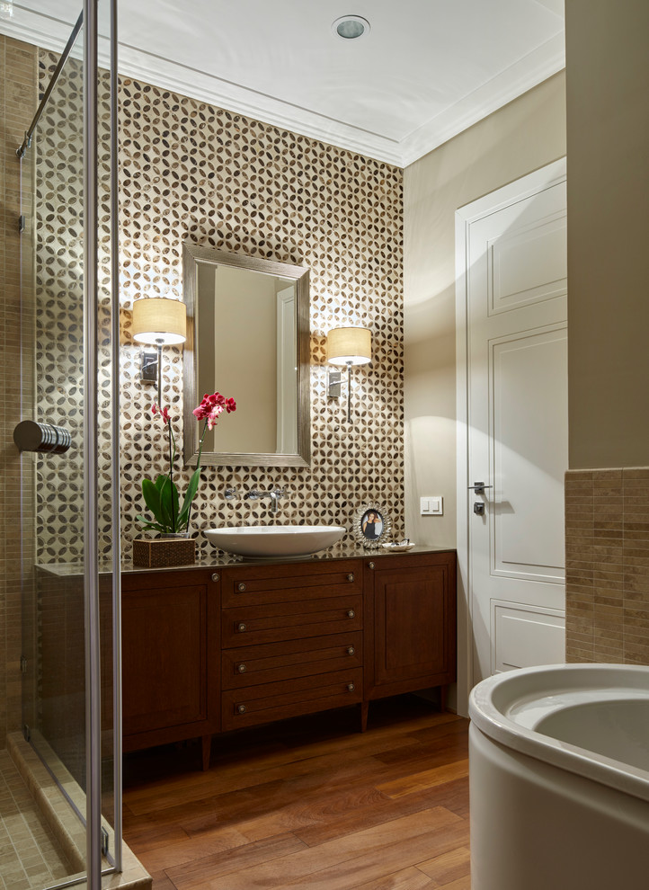 На фото: ванная комната в современном стиле с темными деревянными фасадами, бежевыми стенами, настольной раковиной, бежевой плиткой и душевой кабиной